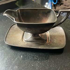Silver plate gravy boat with tray.